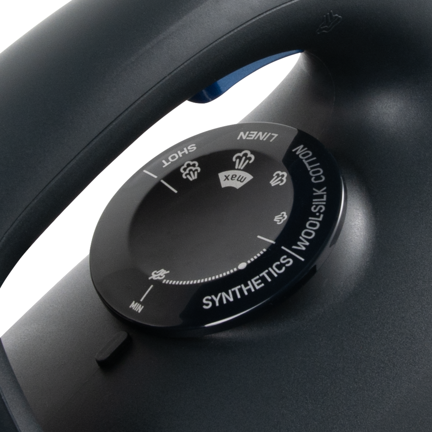 Close-up of a control dial on a black iron. Settings for different fabrics.