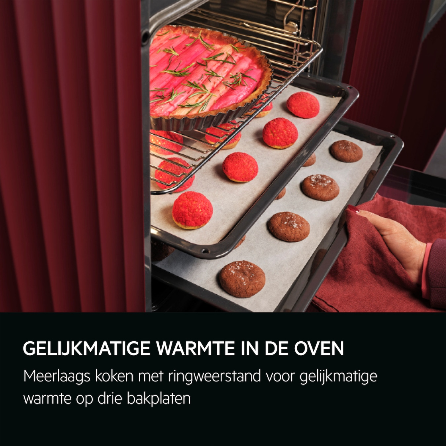 Oven interior with baked goods on trays. A hand holds a red cloth.