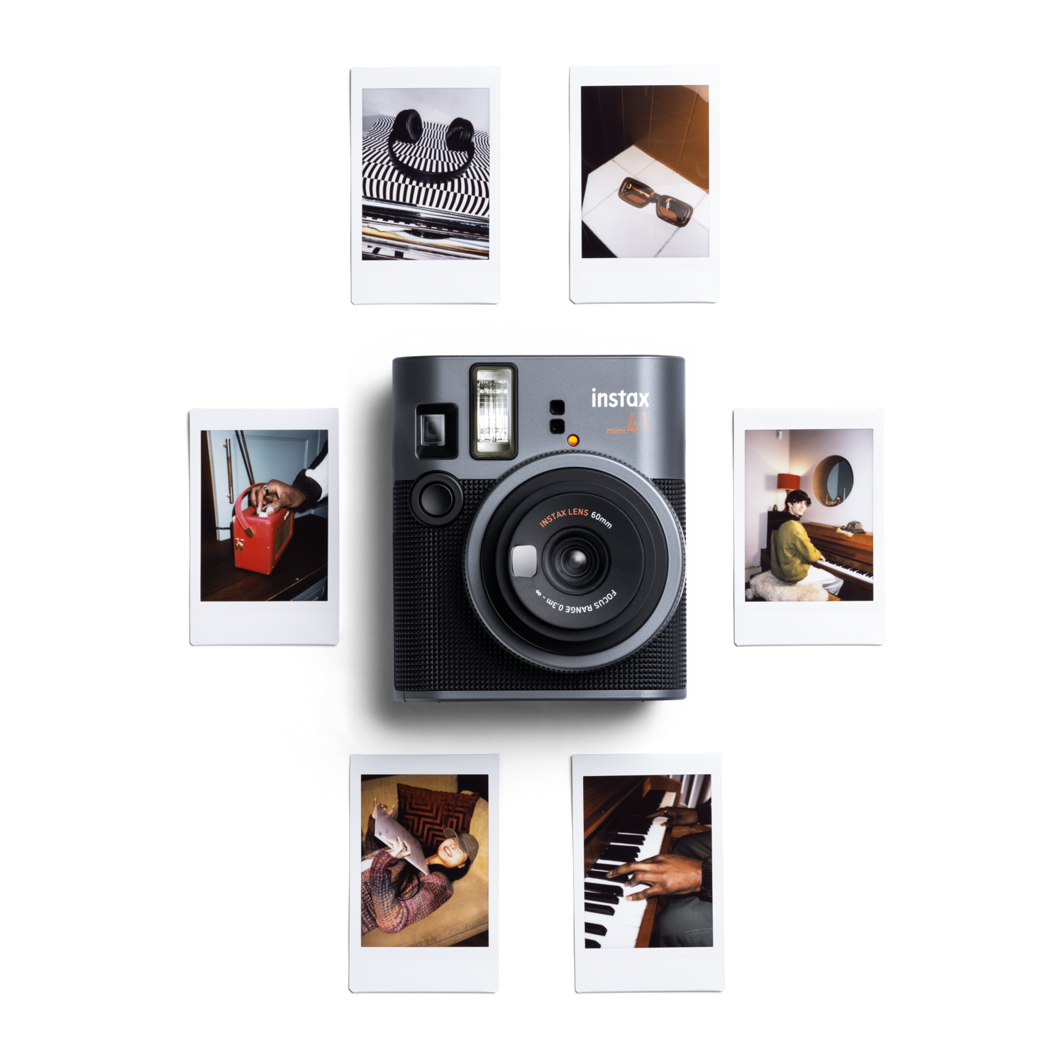 Instax mini 41 camera with various photos around.