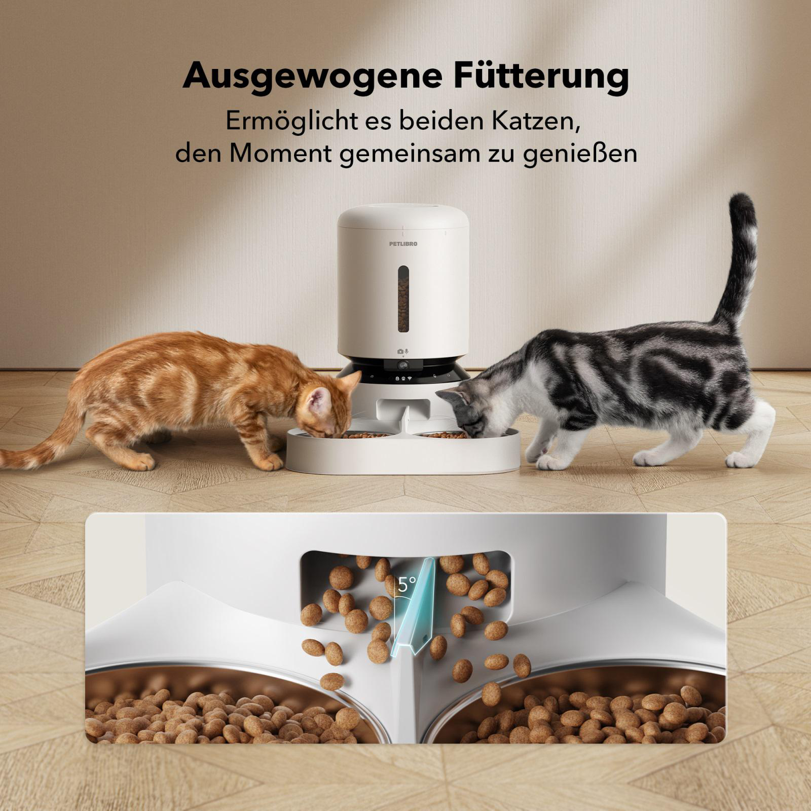 Zwei Katzen essen aus dem Futterautomaten. Der Automat gibt Futter aus. Katzenfutter ist sichtbar.