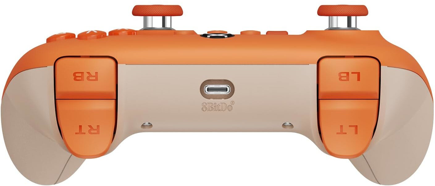 Spód pomarańczowo-białego kontrolera. Widoczne przyciski RB, LB, RT i LT, a także port USB.
