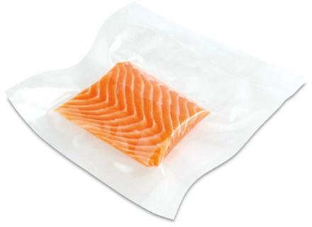 Kawałek łososia w zgrzewanym próżniowo, przezroczystym plastikowym woreczku. Łosoś jest pomarańczowy.