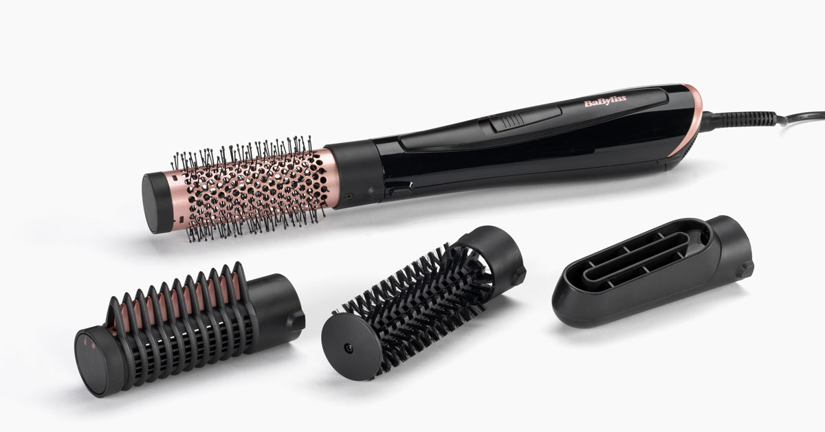 Narzędzie do stylizacji włosów z wieloma załącznikami na białym tle.