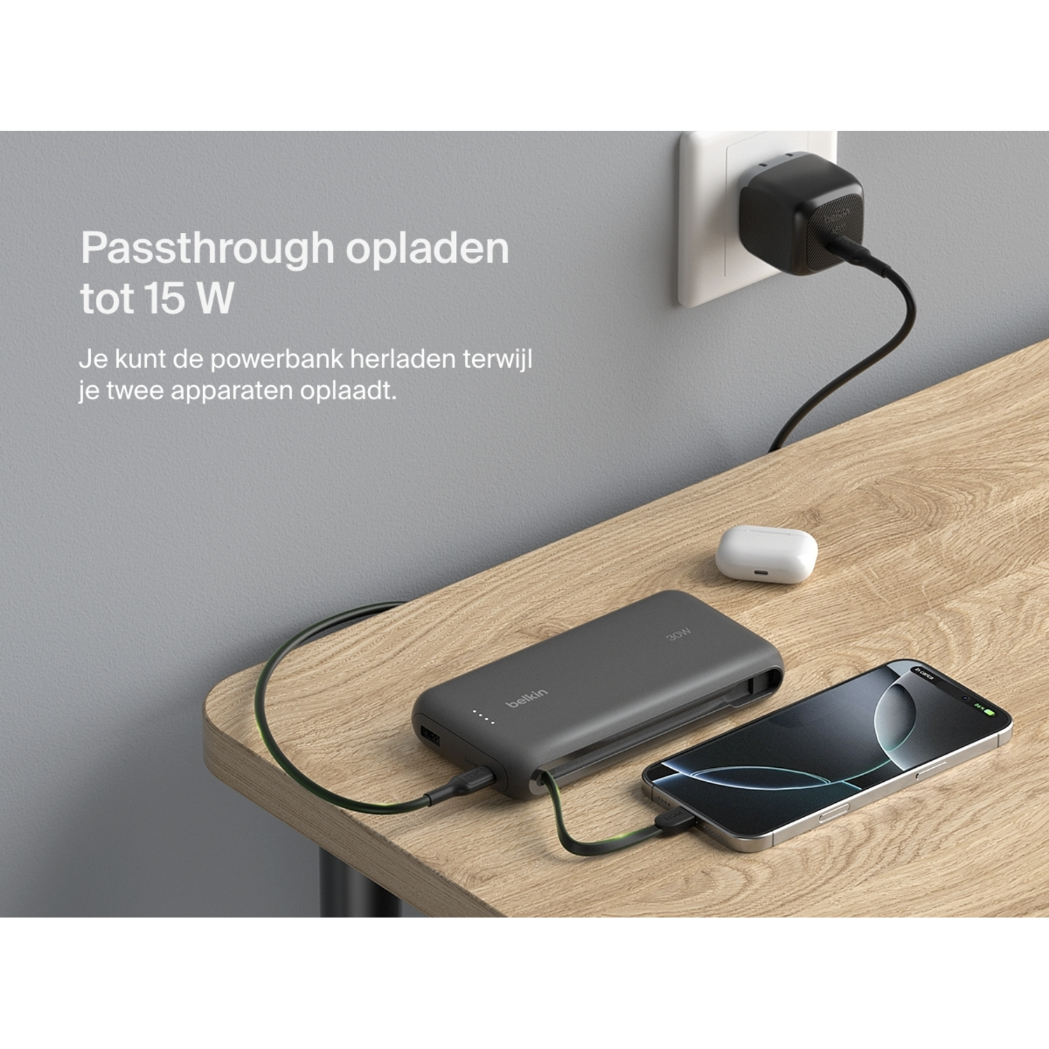 Belkin power bank charging from wall outlet and charging iPhone. A white AirPods case is also on the table.