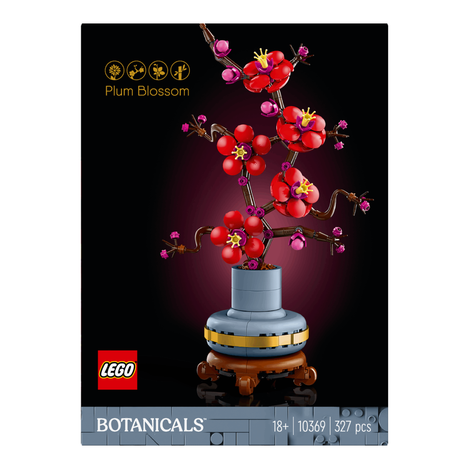 Plum blossom Lego set in een vaas op een standaard. Rode bloemen, bruine takken en een zwarte achtergrond.