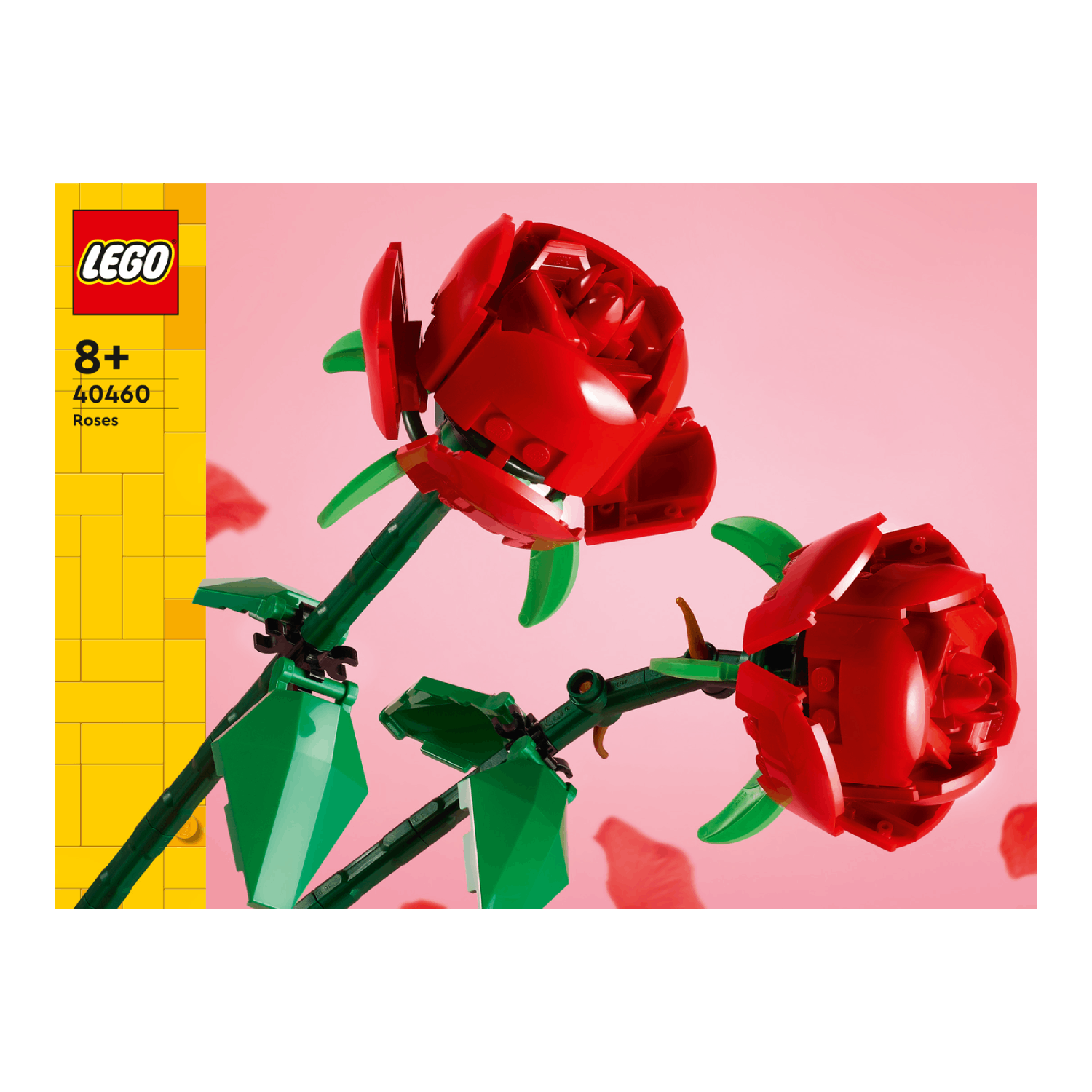 Two Lego roses with red petals, green stems and leaves. A Lego box is in the background.
