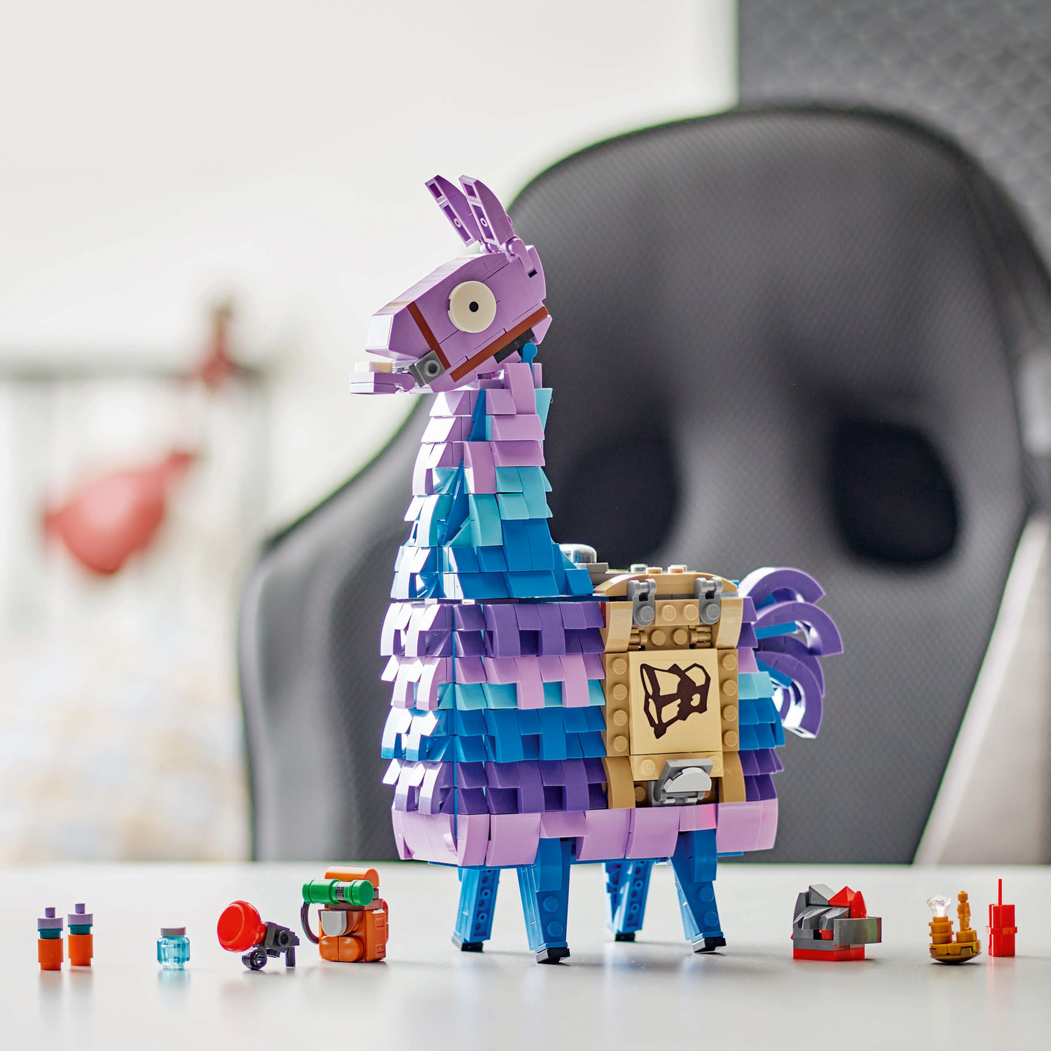 A LEGO Fortnite Llama model and other LEGO items are on a white table.