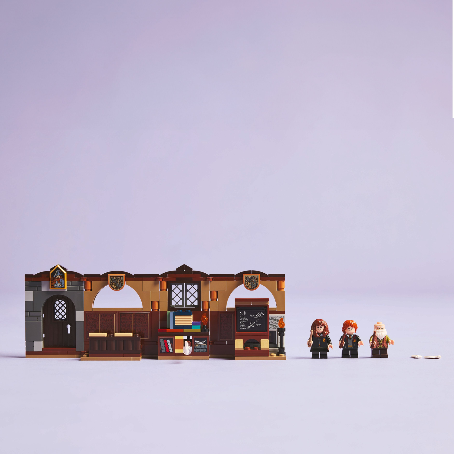 Lego Harry Potter classroom set with minifigures. The set is displayed on purple background.