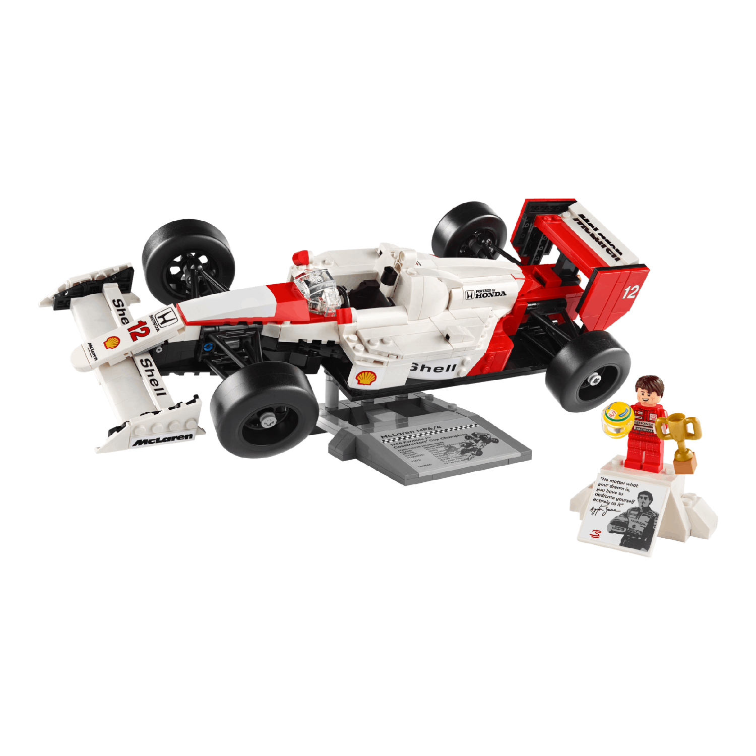 Lego model van een witte en rode McLaren raceauto op een zwarte achtergrond. Een kleine trofee en beeldje.