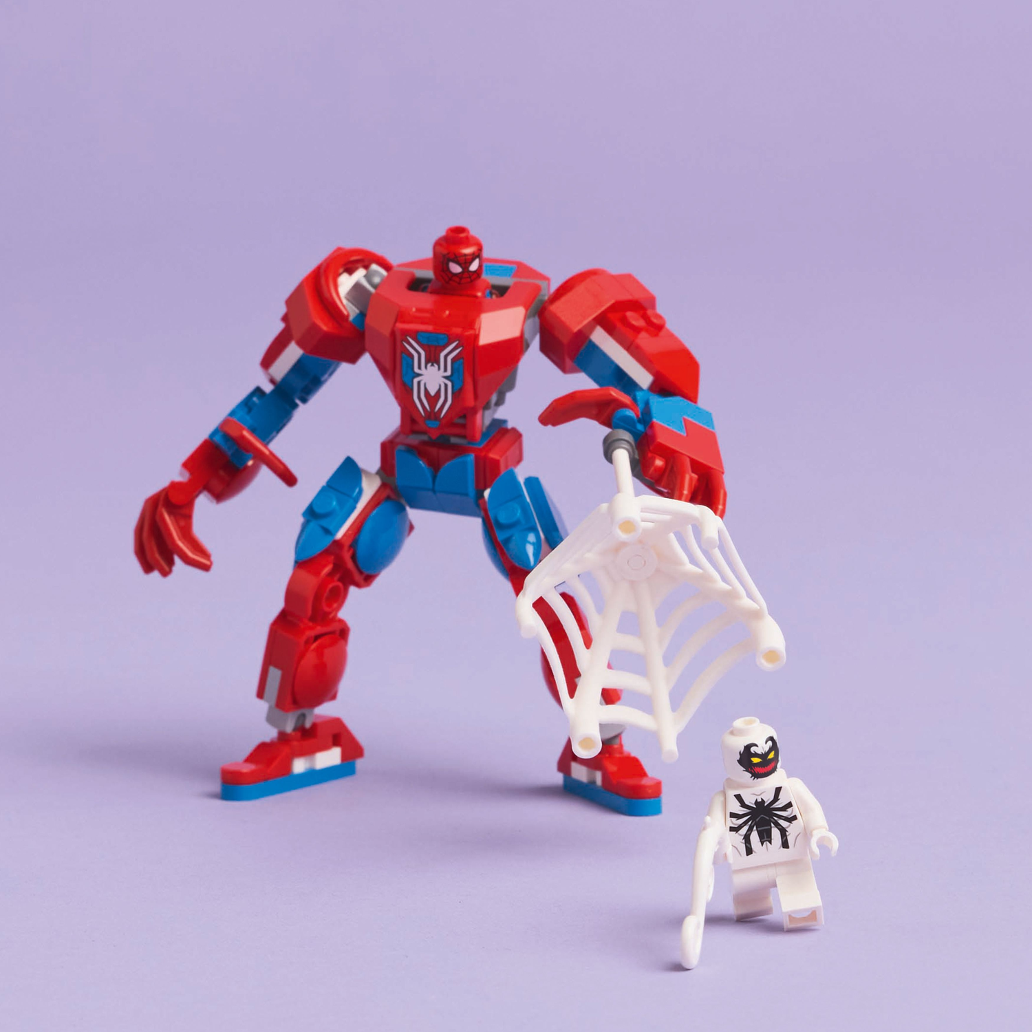 A red, white, and blue Spider-Man mech Lego stands facing an Anti-Venom figure and a white web.