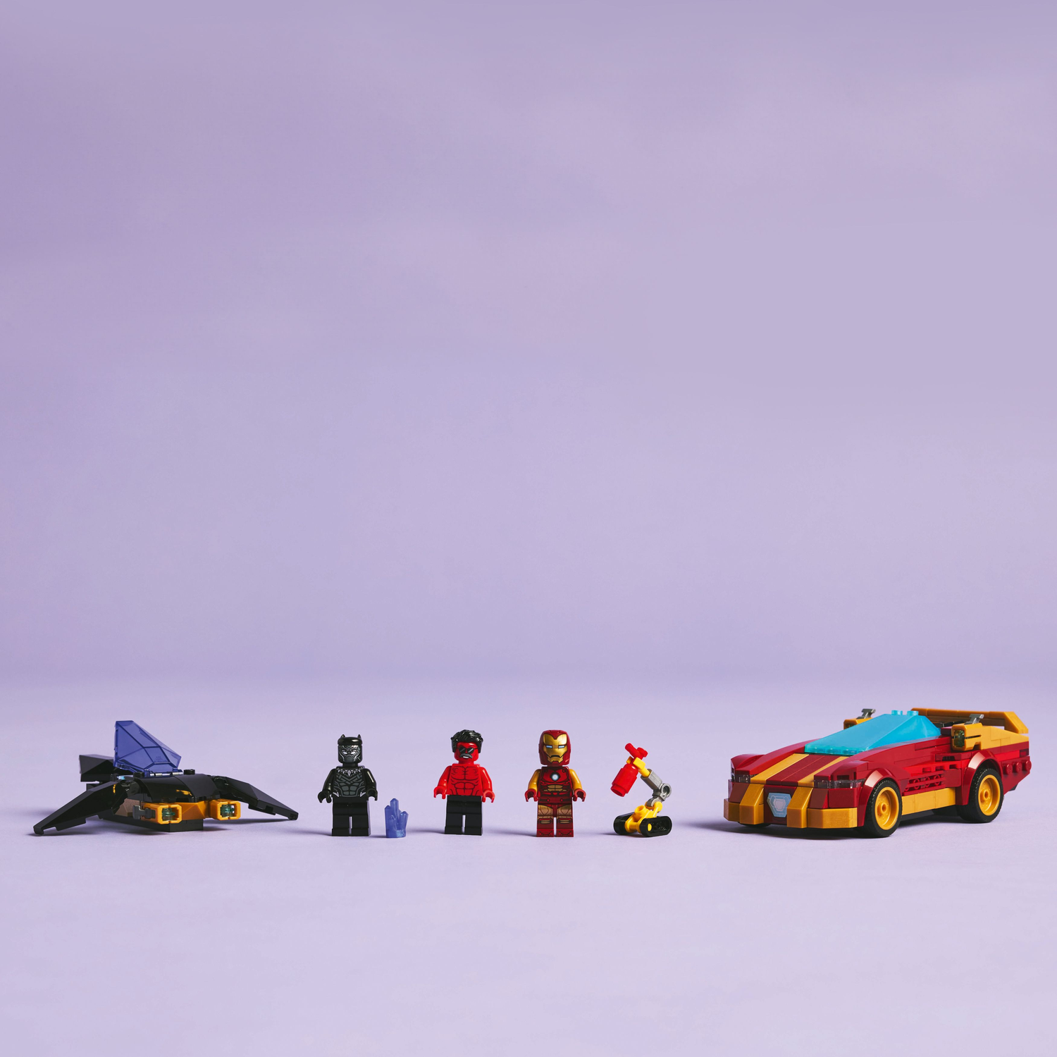 A Lego set with a car, jet, Iron Man, Black Panther, Red Hulk, and a repair station is assembled.