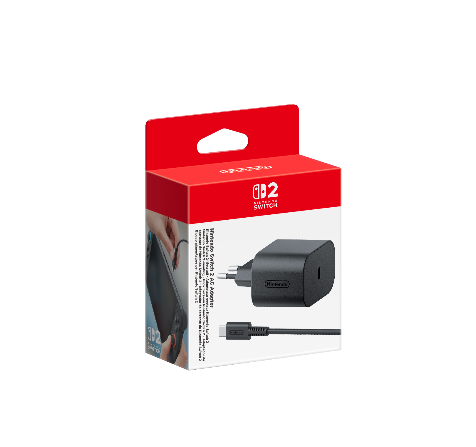 Bir Nintendo Switch 2 AC adaptör kutusu. Kutu kırmızı ve beyaz renktedir. Siyah bir adaptör ve kablo görünür.