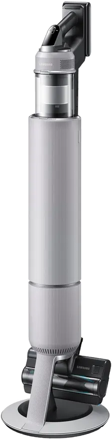 Aspirateur vertical sur socle de chargement. Corps blanc avec poignée et tête de nettoyage fixées.