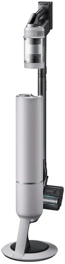 Aspirateur vertical sur socle de chargement. Corps blanc, poignée noire avec commandes et base.