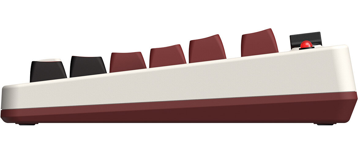 Widok z boku klawiatury retro. Bordowe klawisze, biała rama. Niektóre klawisze są czarne.