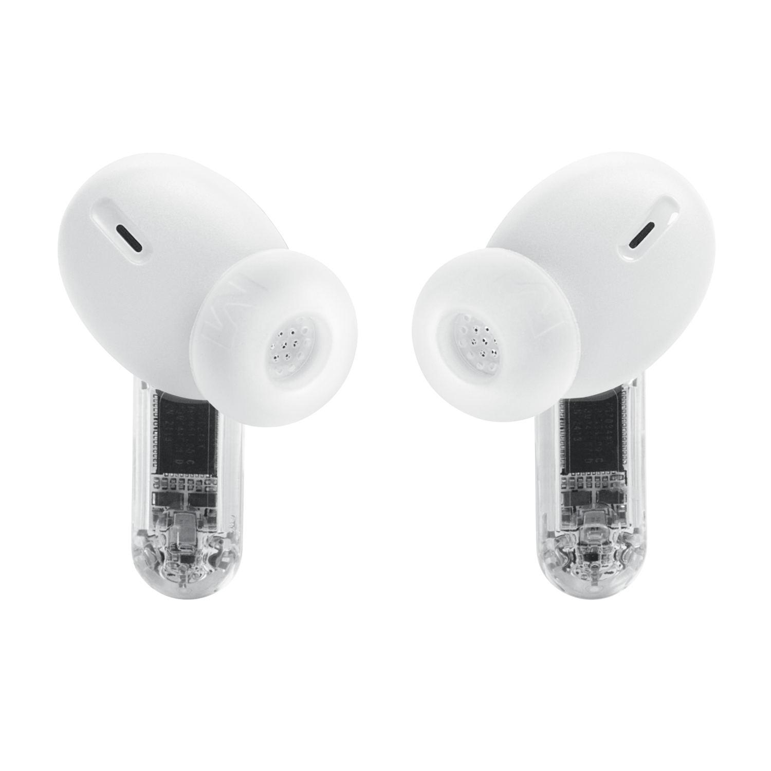 Deux écouteurs JBL blancs, gros plan, montrant les composants internes. Fond noir.