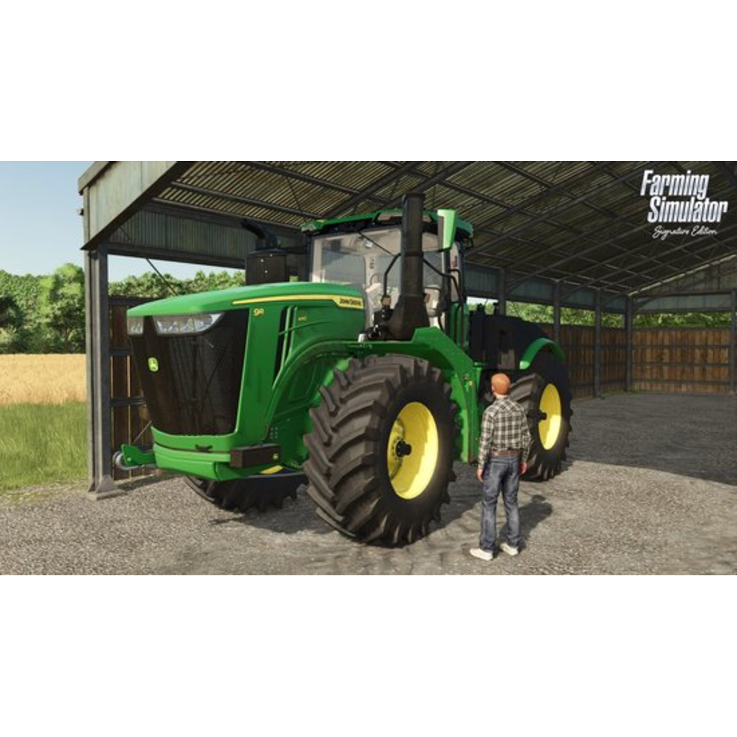 Een groene tractor geparkeerd onder een schuur met een persoon ervoor.