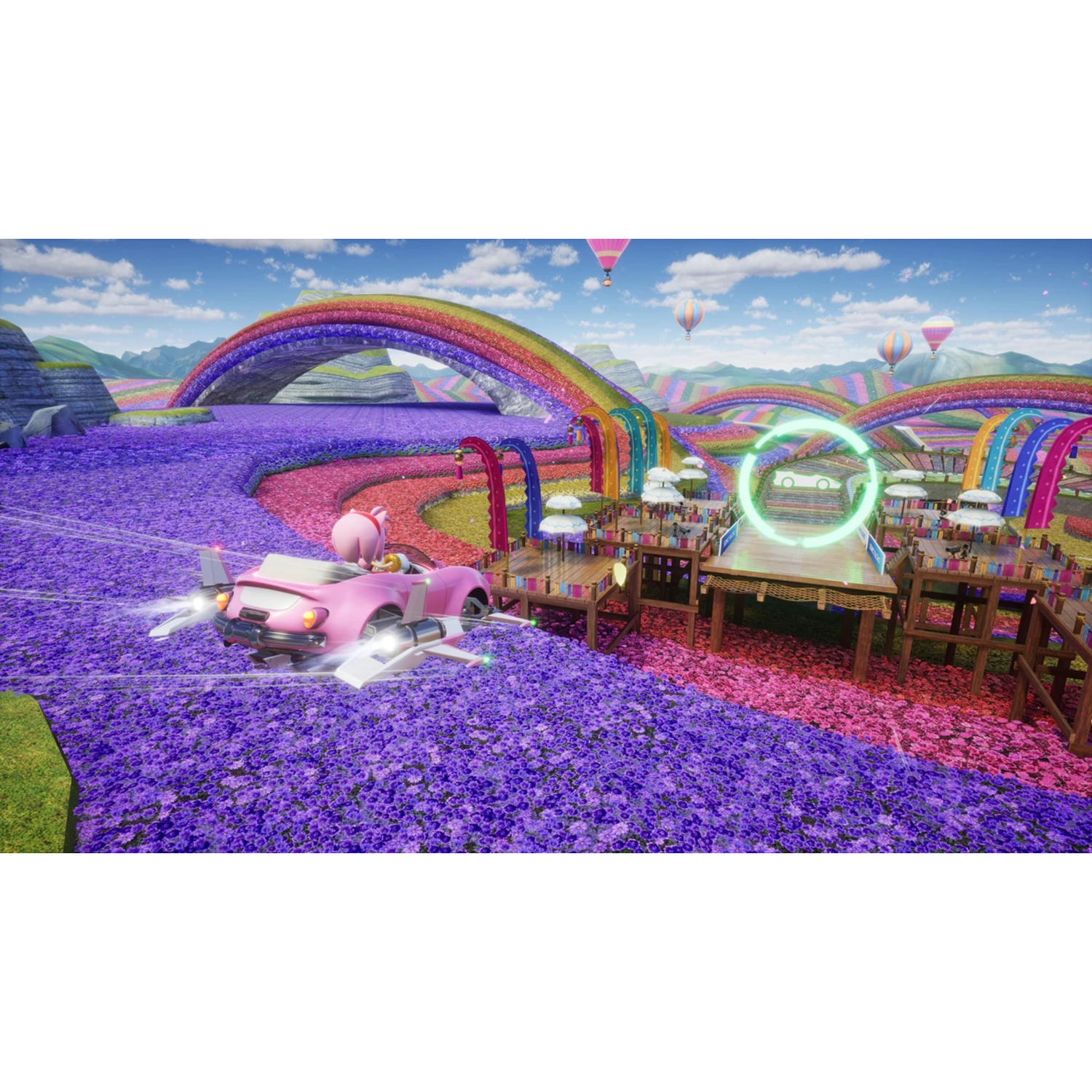 Amy Rose in a pink car racing on a track with a rainbow and flower field background.