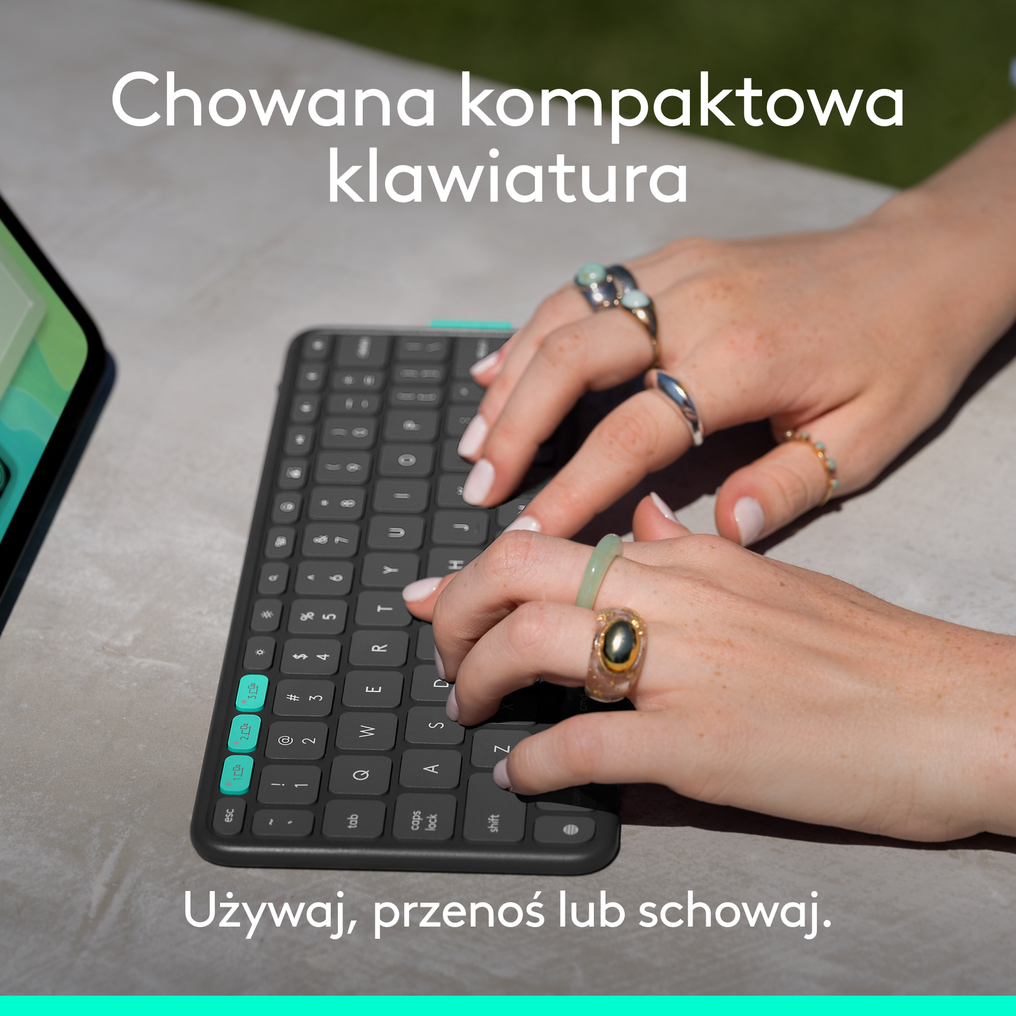 Dłonie z pierścionkami piszące na klawiaturze. Tekst 'Hidden compact keyboard' i 'Use, carry or hide'.
