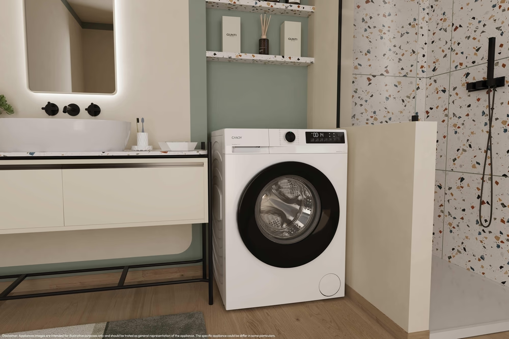 Una lavatrice bianca in un bagno. Un lavandino e uno specchio a sinistra. Doccia con piastrelle colorate a destra.