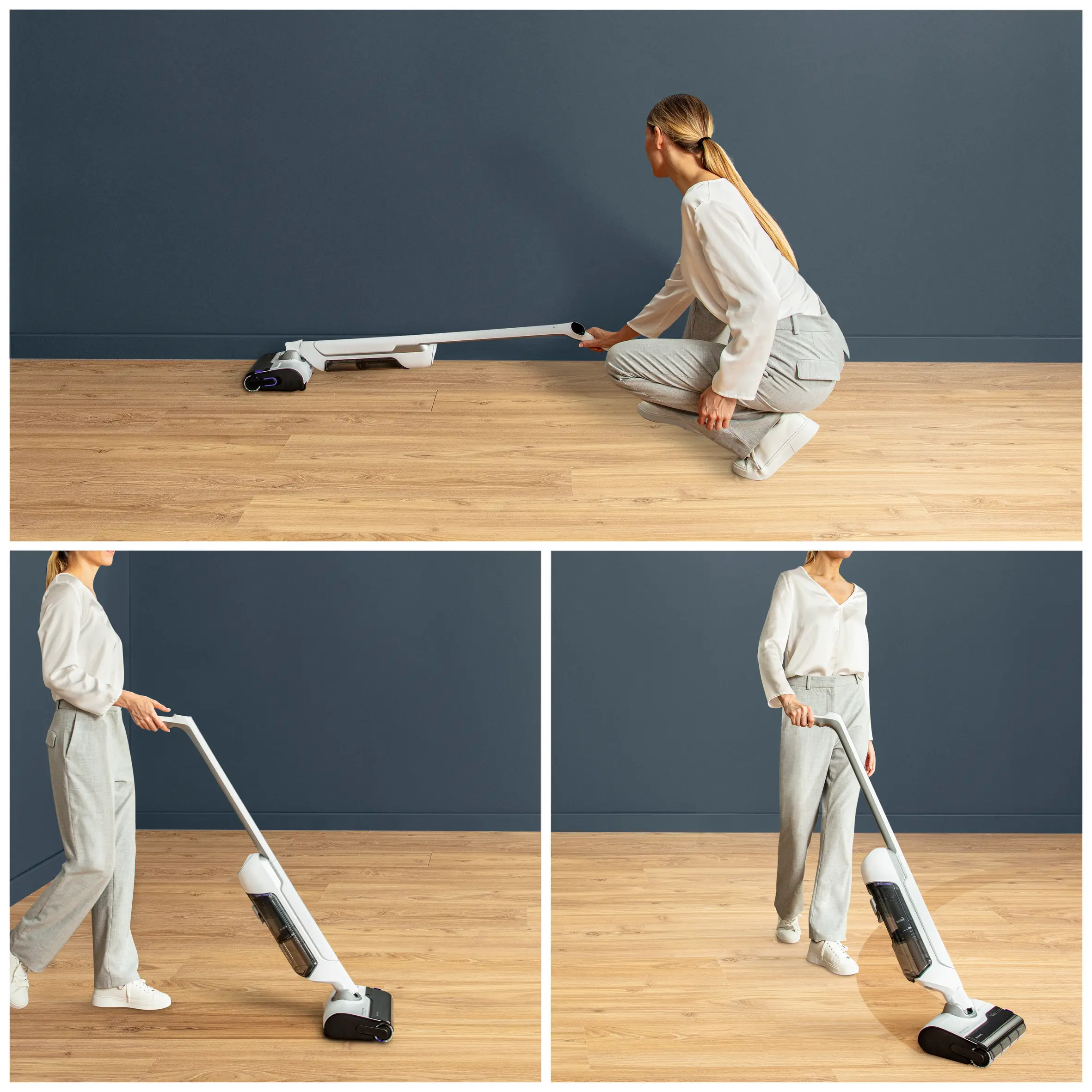 Femme utilisant un aspirateur sans fil blanc sur un plancher en bois. Mur bleu foncé en arrière-plan.