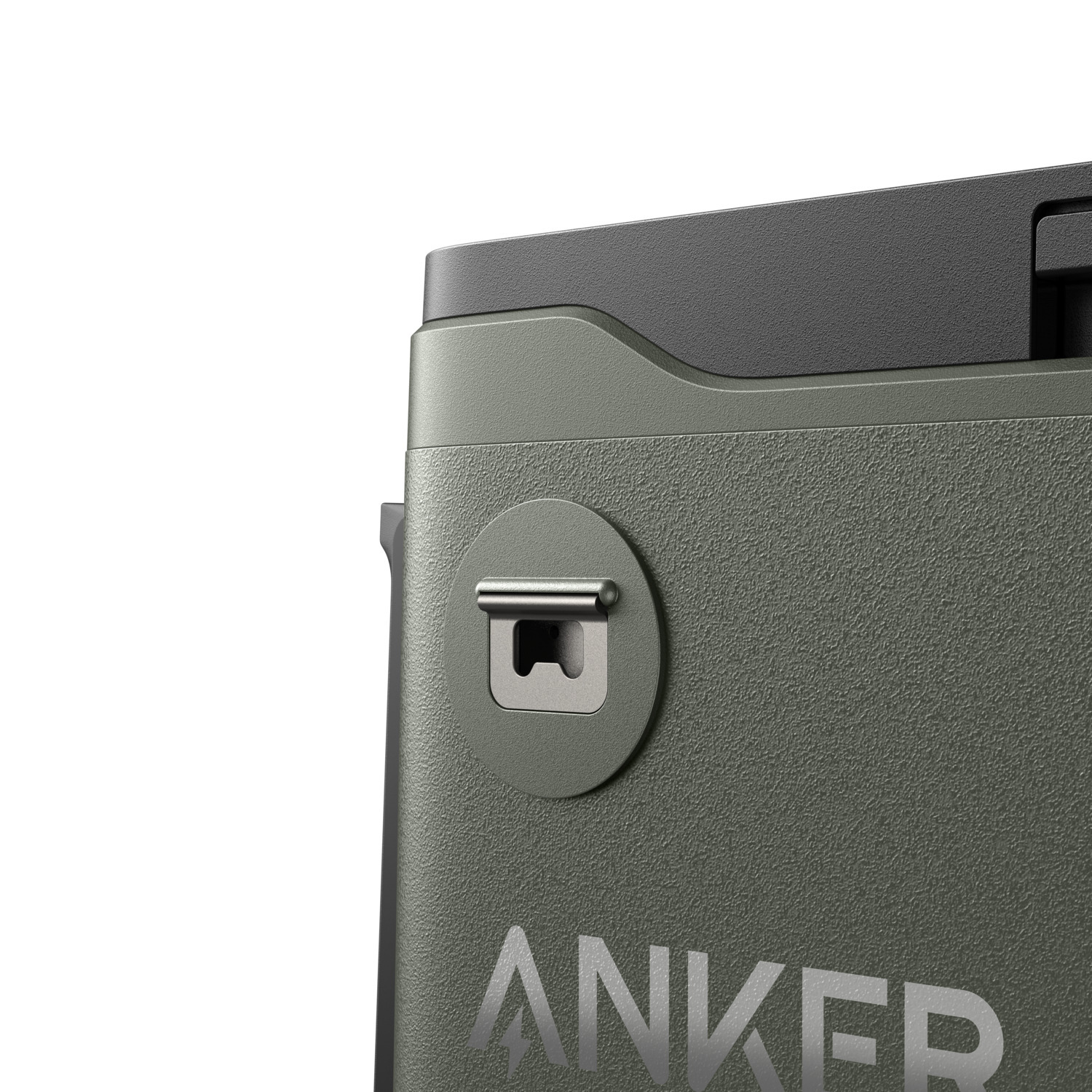 Close-up of an olive green ANKER device. Features include a silver latch, textured surface, and a black top section.