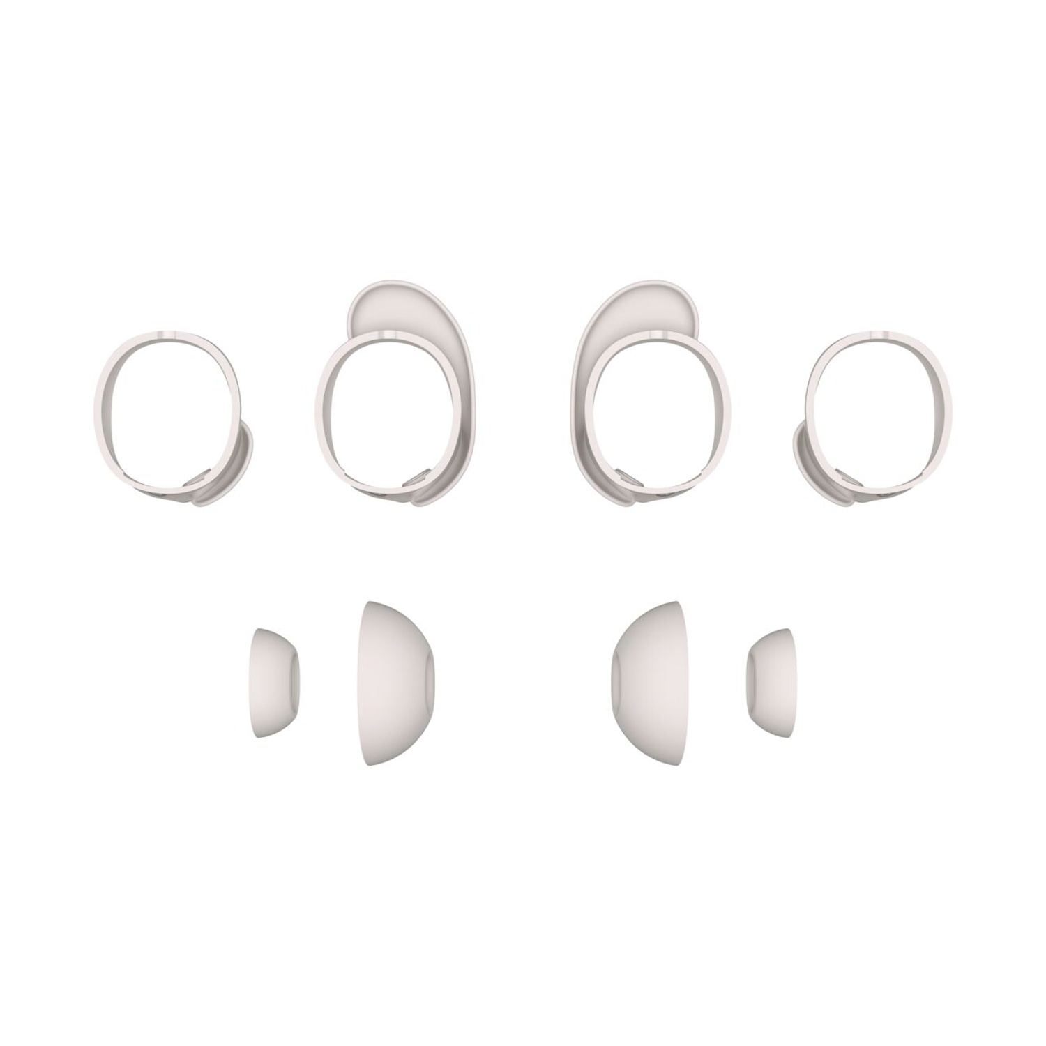 Auricolari e adattatori bianchi su sfondo bianco. Sono visibili quattro telai e punte auricolari.