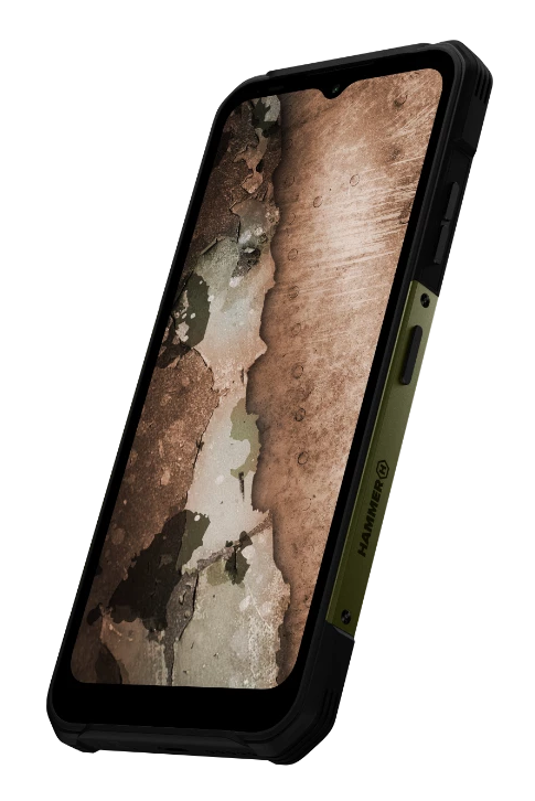 Wytrzymały smartfon z czarną i oliwkową obudową, wyświetlający obraz zniszczonej ściany.