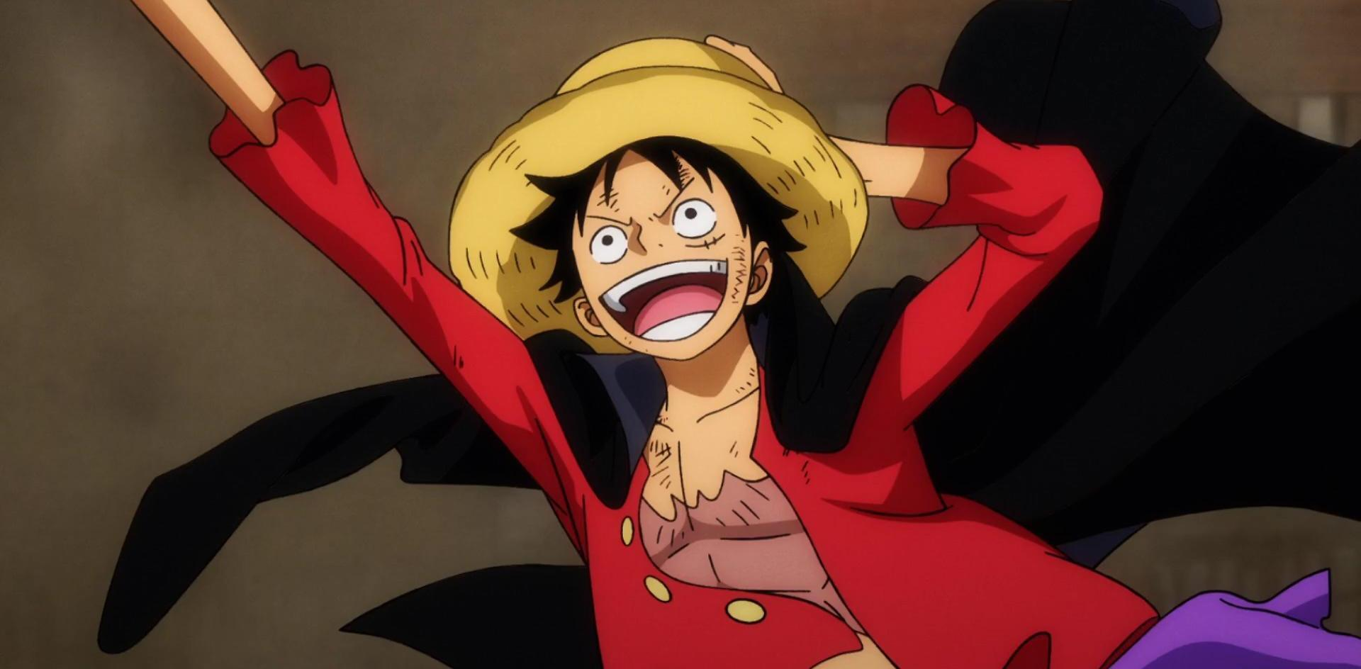 Anime-Figur Luffy mit Strohhut, offenem Mund, rotem Mantel, schwarzem Umhang, erhobenen Armen. Fröhlicher Ausdruck und verschwommener brauner Hintergrund.