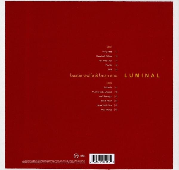 Roter Albumcover mit goldenem Text. Listet Songs von Beatie Wolfe & Brian Eno.