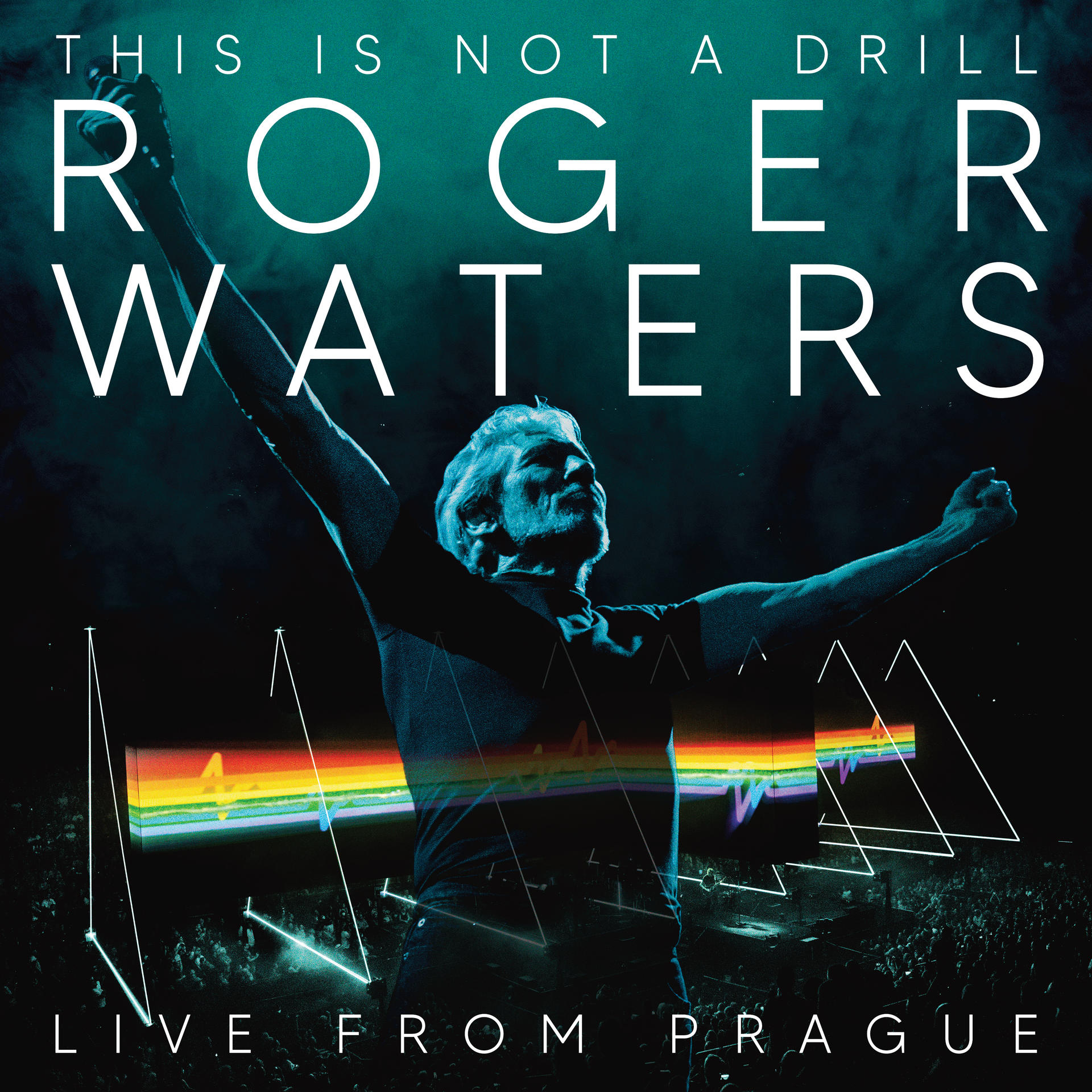 Roger Waters live in Prag. Mann mit erhobenen Armen. Regenbogen-Prismengrafik. Tourtitel oben und unten.