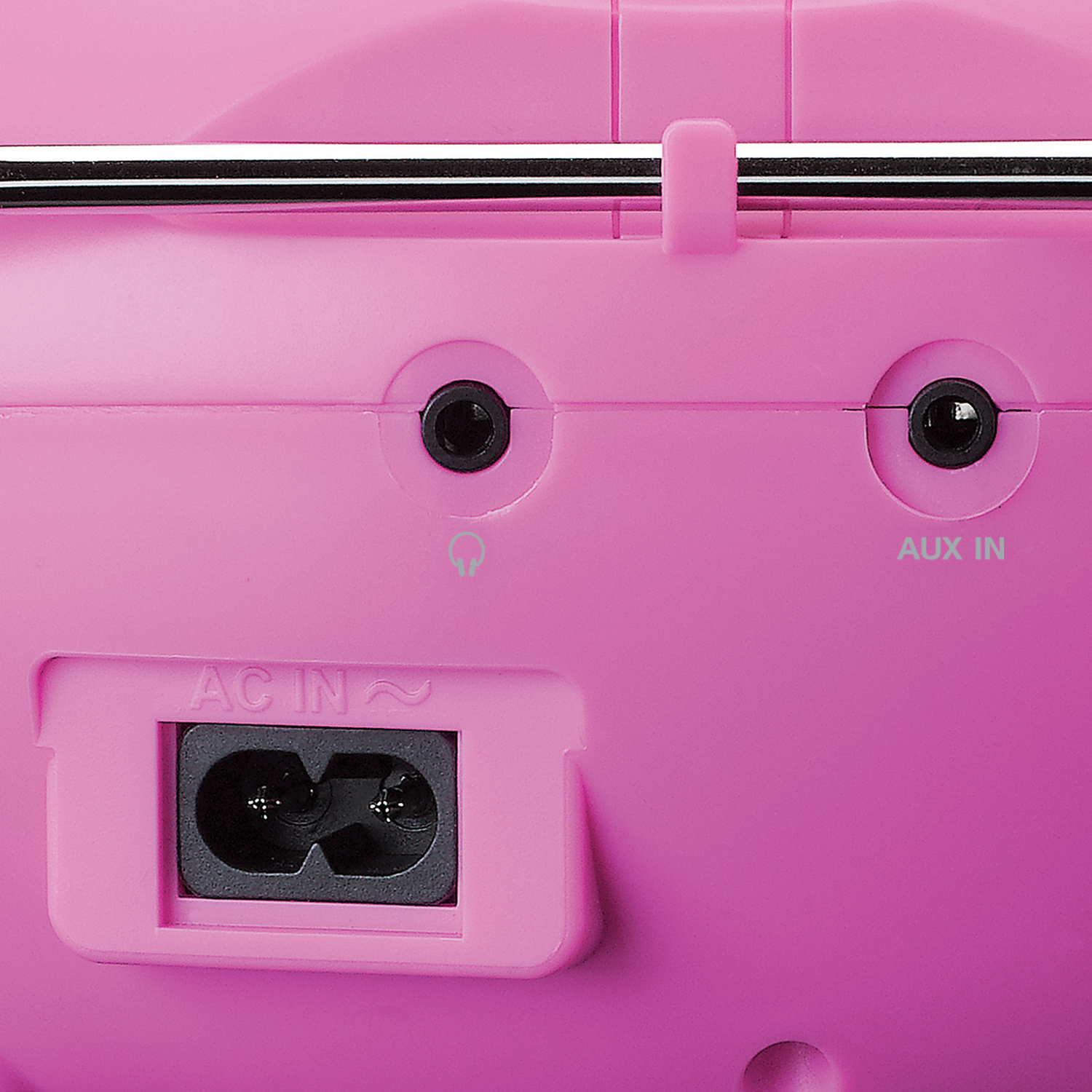 Close-up of a pink radio's back panel. It shows AC IN, AUX IN ports, and a headphone jack symbol. A metal antenna is also visible.