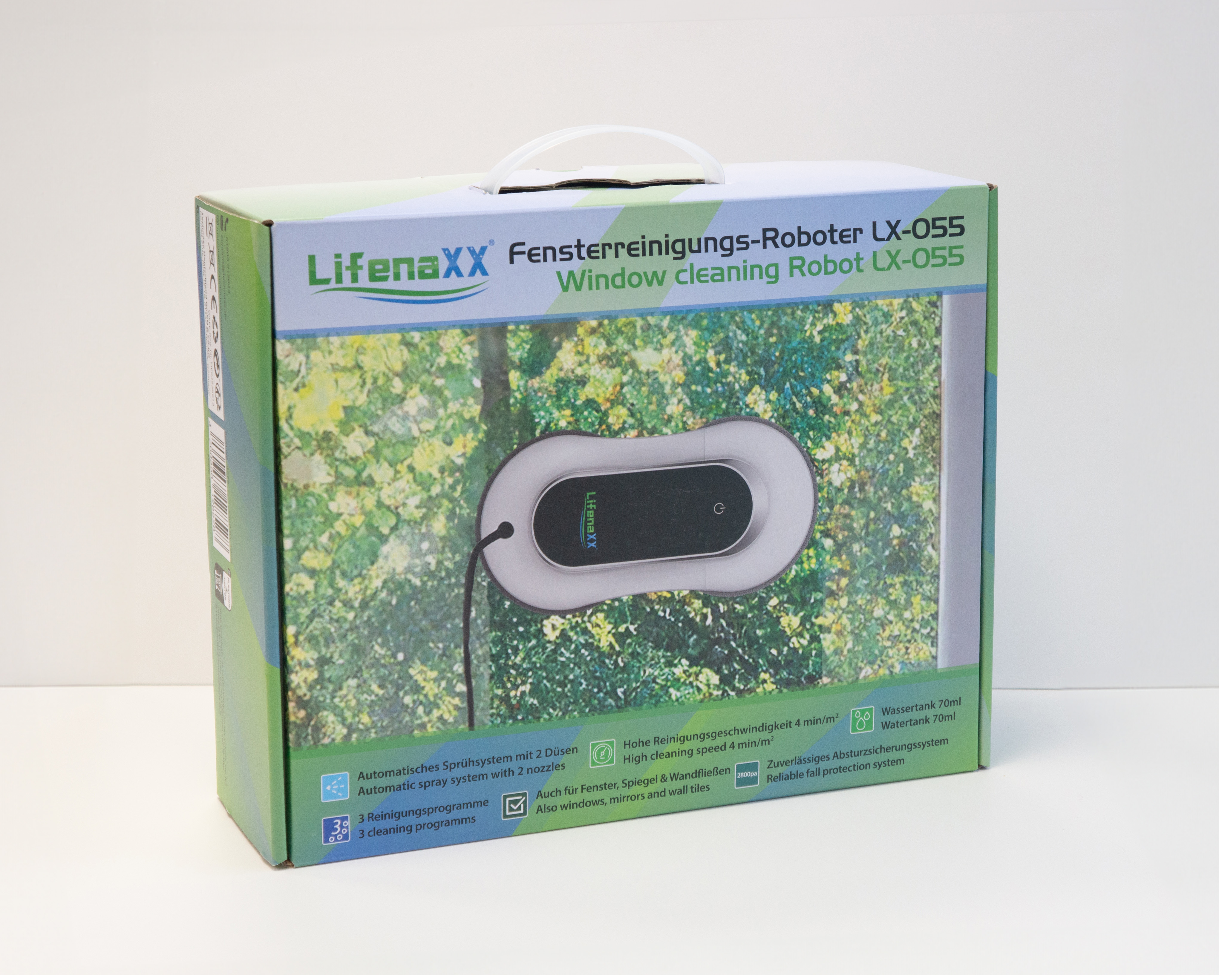 Pudełko robota do czyszczenia okien. Ma uchwyt, a robot znajduje się na tle zielonego liścia.