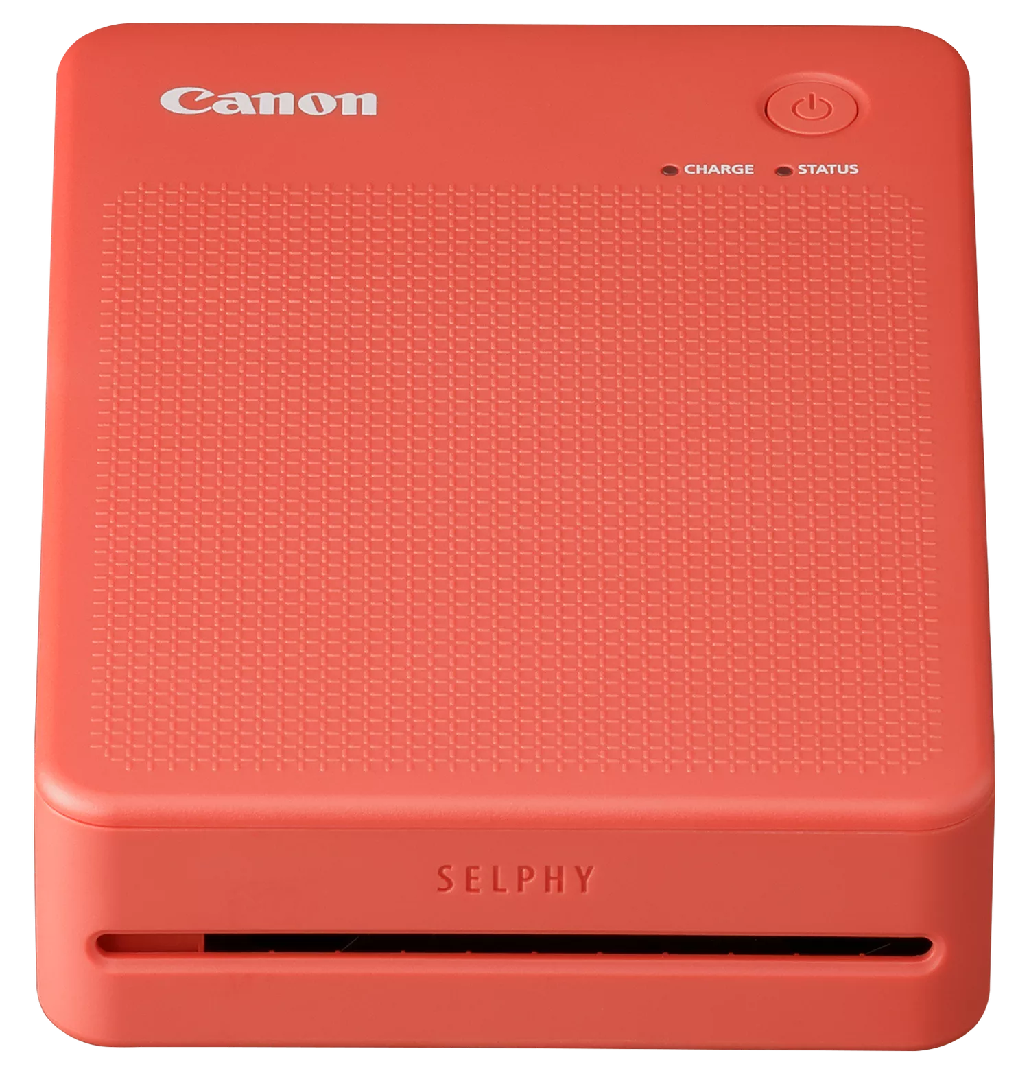 Koralowa drukarka Canon Selphy. Przycisk zasilania, kontrolki ładowania i statusu. Teksturowana powierzchnia. Logo SELPHY. Czarne tło.