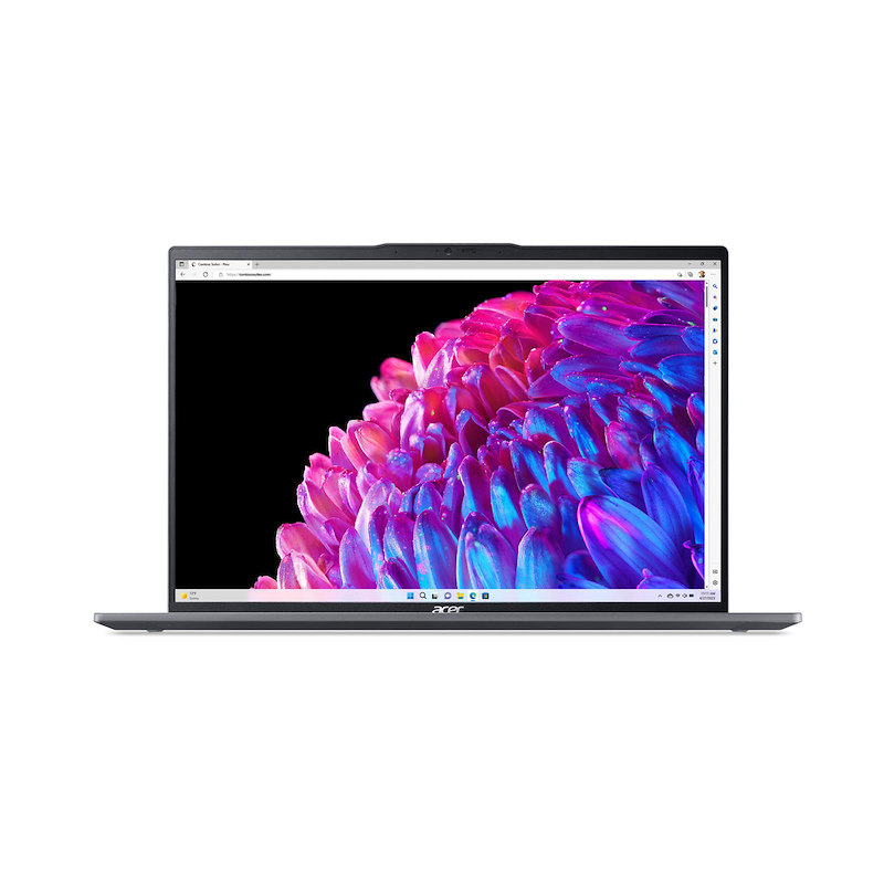 Un portátil Acer plateado muestra una imagen floral colorida. La pantalla muestra pétalos rosas, azules y morados sobre un fondo negro.