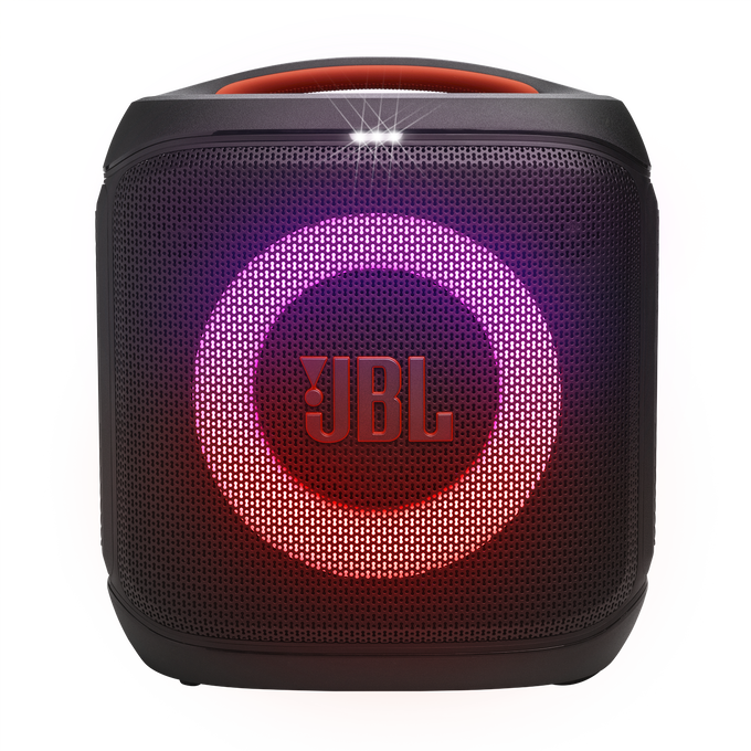 Altavoz JBL negro con anillo y logotipo brillantes. Asa roja en la parte superior. Fondo borroso y colorido.