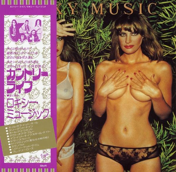 Albumcover: Zwei oben ohne Frauen in Dessous. Eine bedeckt ihre Brüste, die andere ist teilweise sichtbar. Grüner Laub Hintergrund.