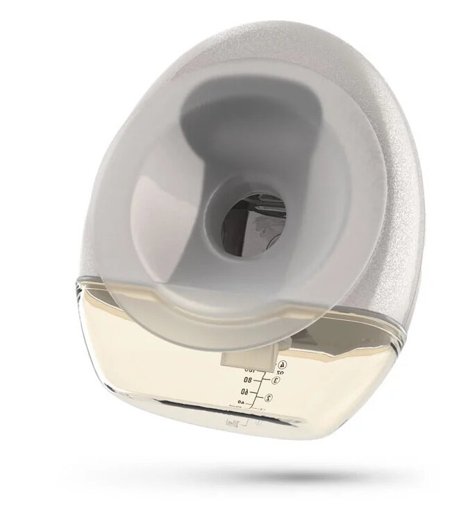 Laktator, przeważnie biały i przezroczysty, ze zbiornikiem pomiarowym. Ma zakrzywiony kształt i stoi na białej powierzchni.