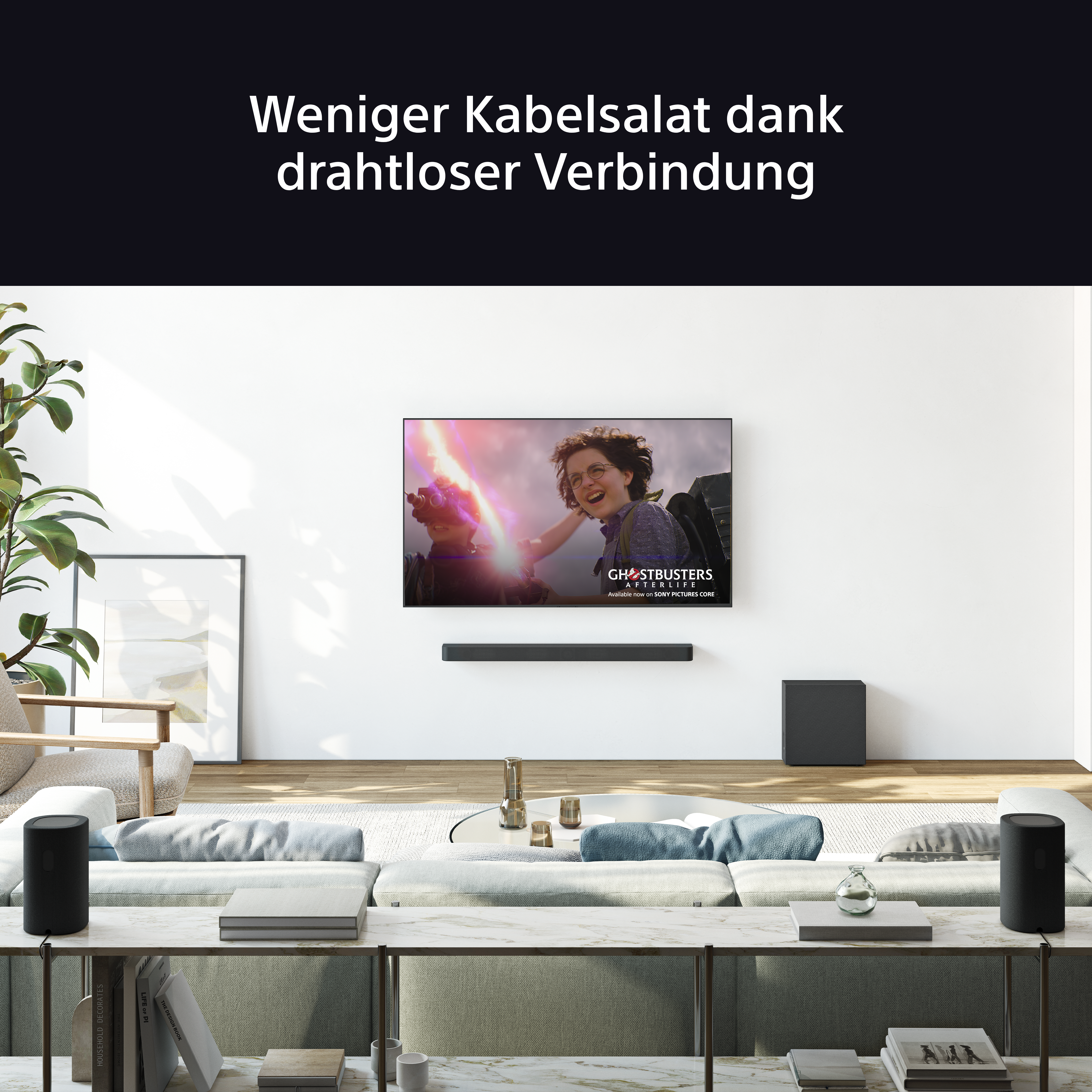 Ein Wohnzimmer mit einem Fernseher, der Ghostbusters zeigt, einer Soundbar, Lautsprechern und einem Sofa. Der Text lautet 'Weniger Kabelsalat'.