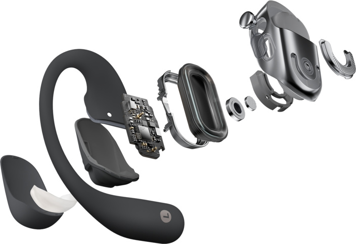 Vue éclatée d'un casque à conduction osseuse noir et argenté, montrant les composants internes comme le circuit imprimé et le haut-parleur.