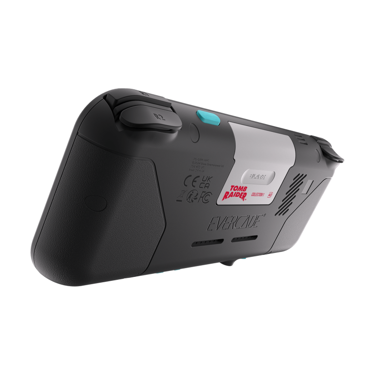 Konsola przenośna Evercade z kolekcją Tomb Raider. Jest czarna, szara i biała, z niebieskimi przyciskami. Tło jest czarne.