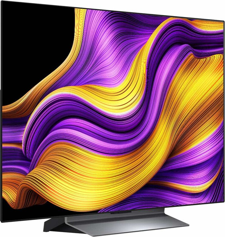 Ein Fernsehbildschirm, der abstrakte Kunst mit wirbelnden gelben, lila und orangen Farben zeigt. Es ist auf einem silbernen Ständer montiert.
