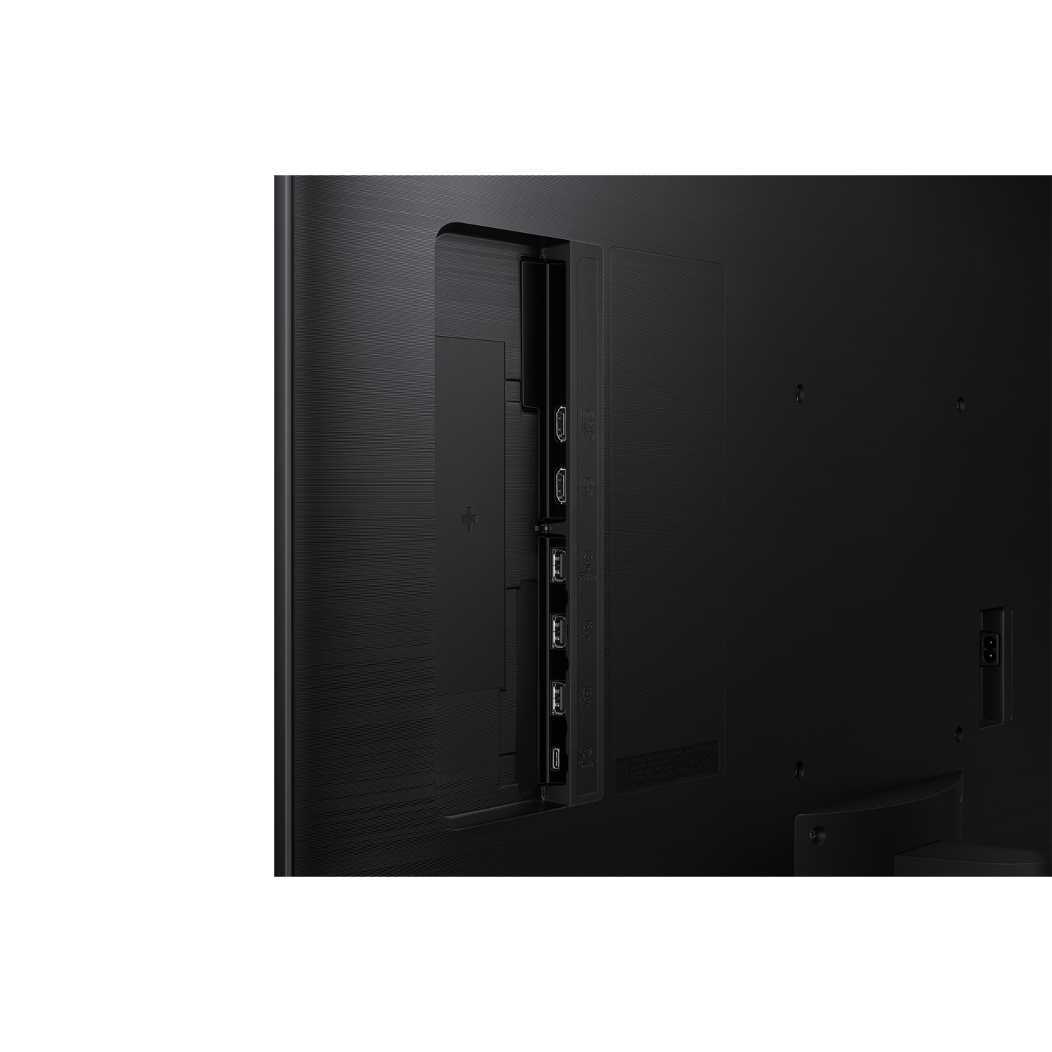Back of a black TV showing ports, including HDMI and USB. The surface has a textured pattern. The background is black.