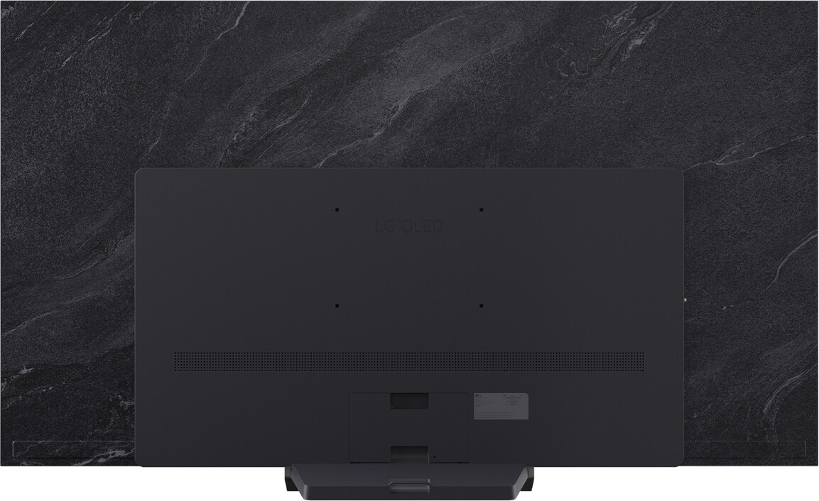 TV LG OLED nero su sfondo scuro e marmorizzato. Visibile la parte posteriore del televisore.