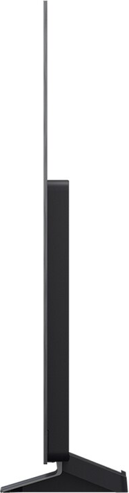 Vue latérale d'une télévision noire. Elle a un écran fin et une base rectangulaire pour le support. La TV est moderne et élégante.