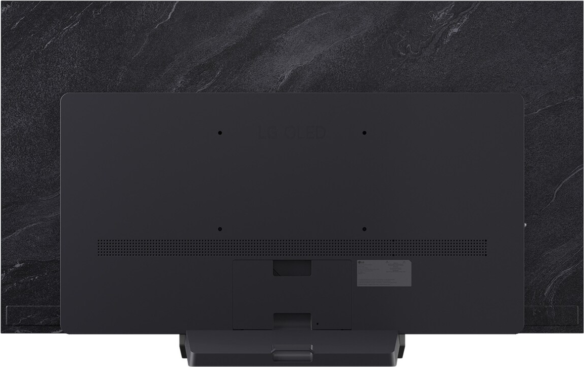 Retro di una TV OLED LG nera su un muro di marmo grigio. La TV ha un supporto in basso. LG OLED è scritto sulla TV.