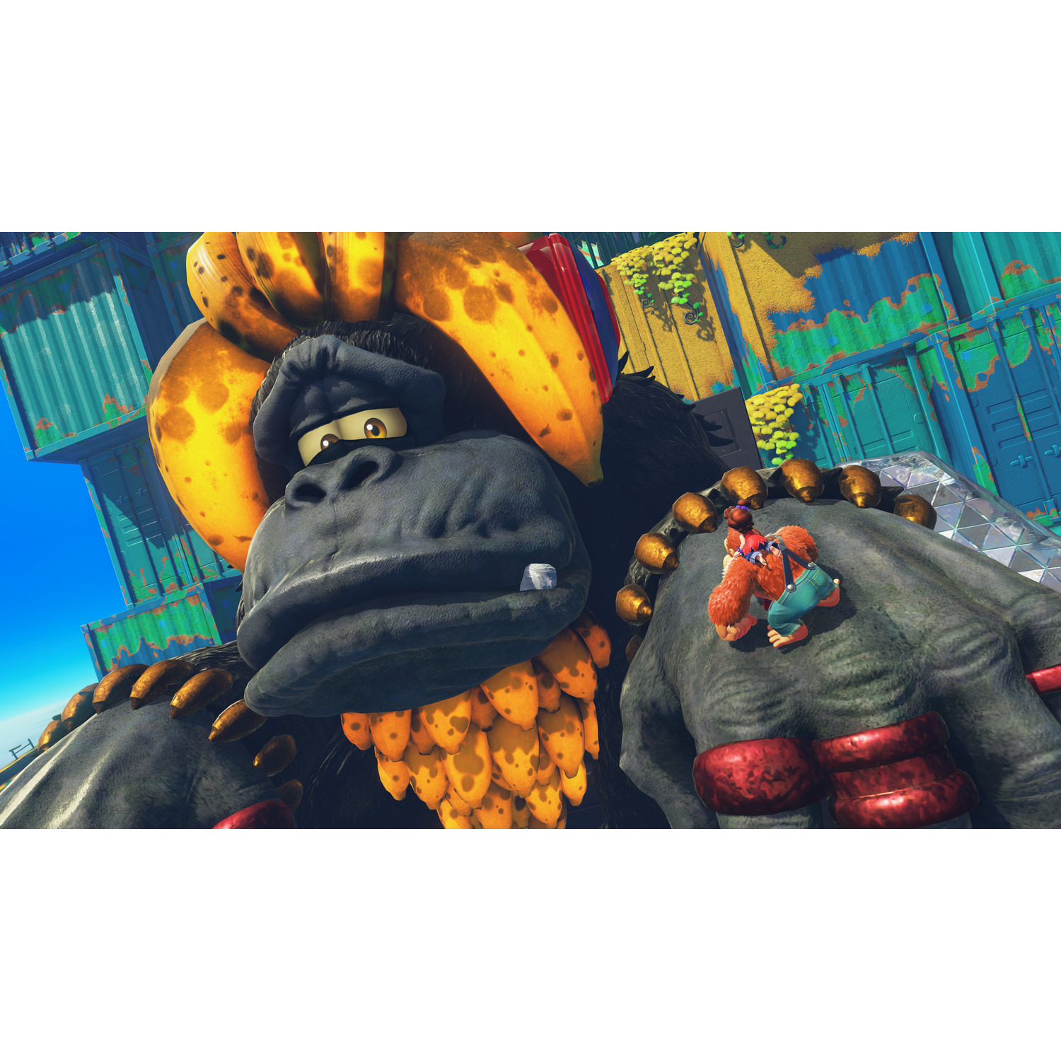Een grote gorilla met bananenhaar en kleine figuren op zijn hand. Achtergrond heeft containers en een blauwe lucht.