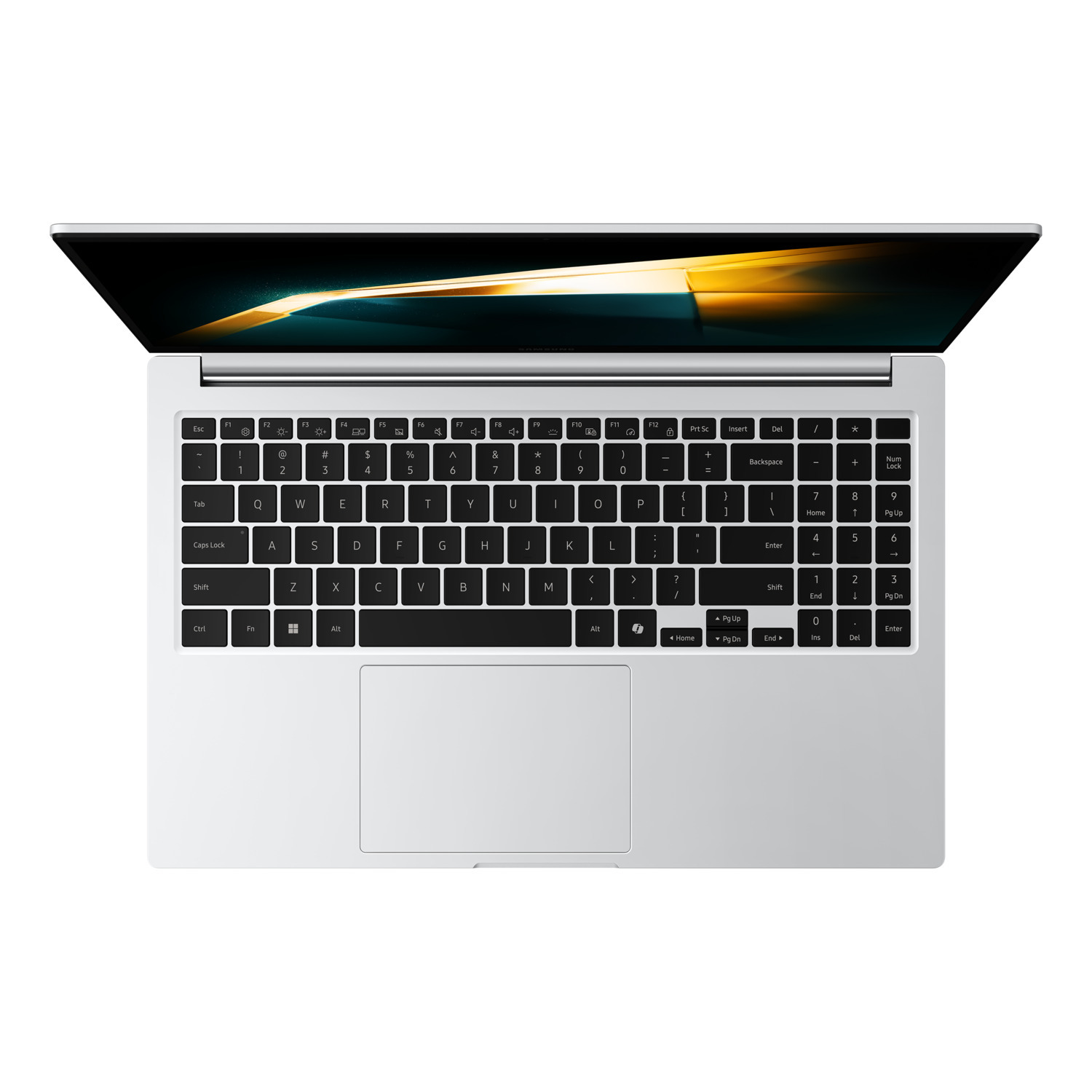 A silver laptop with a black keyboard is open. The screen shows a dark gradient. The keyboard has white keys and black letters.