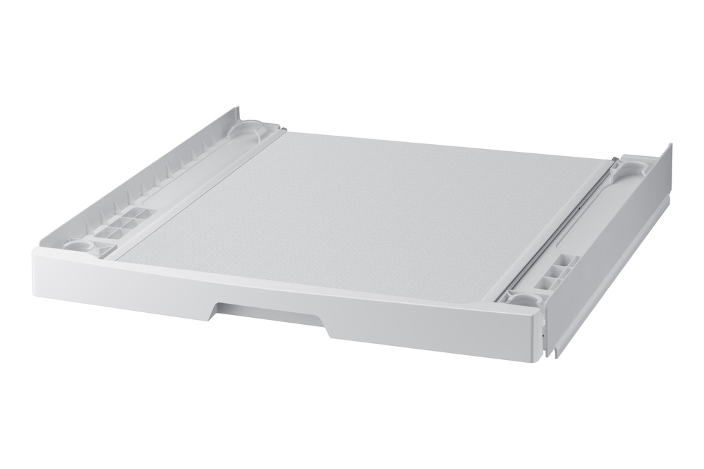 Una base blanca y rectangular para lavadora con superficie texturizada. Tiene bordes elevados con ranuras y una bandeja extraíble.