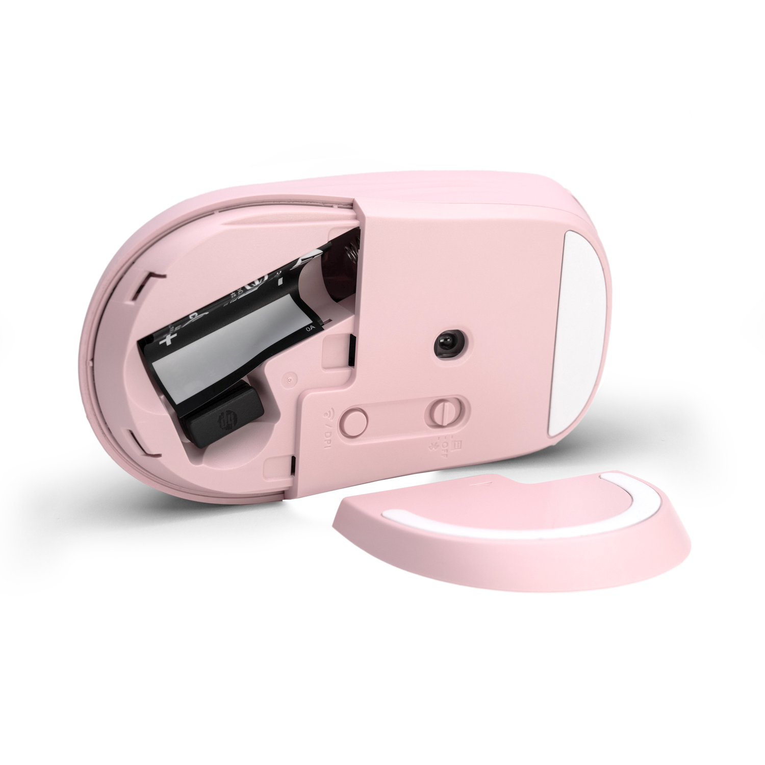 Souris d'ordinateur rose avec le compartiment à piles ouvert. Une pile est visible à l'intérieur. Le couvercle détaché est à droite.